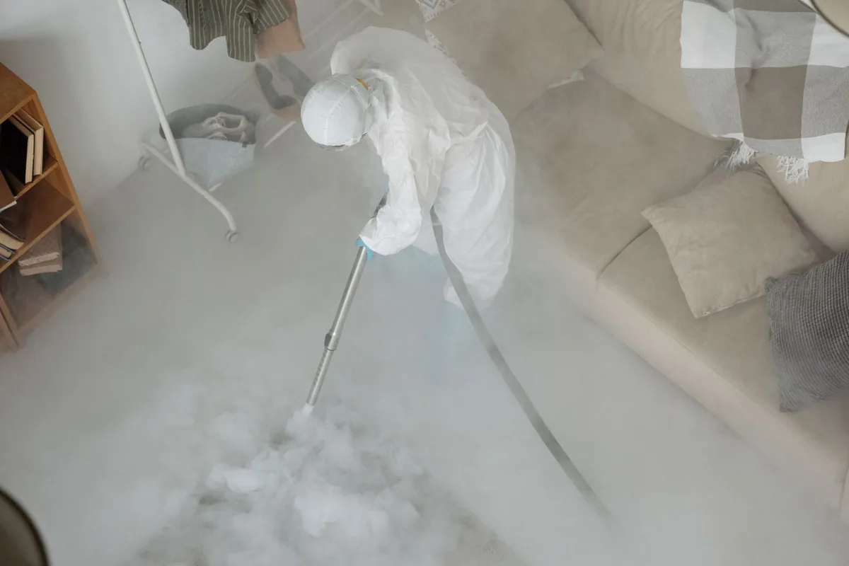 Biohazard cleanup technician in protective equipment, Lake Mohawk, OH